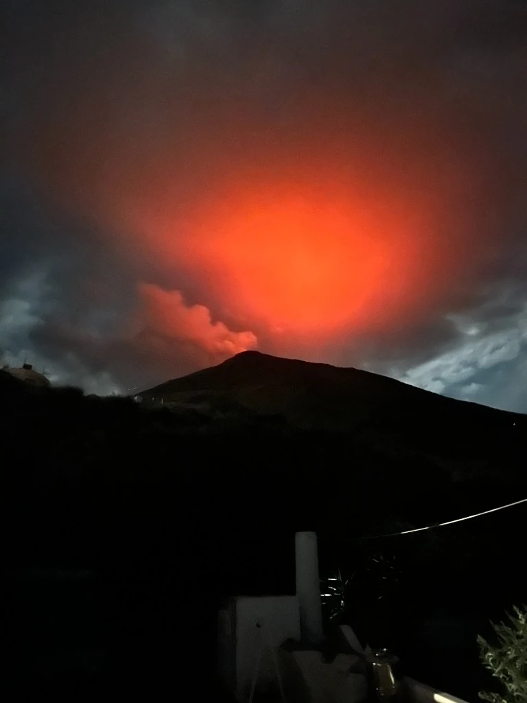Vulcano di Stromboli al tramonto con bagliore rosso nel cielo
